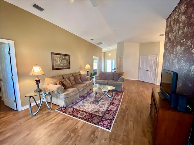 living room featuring ceiling fan, lofted ceiling, and hardwood / wood-style floors