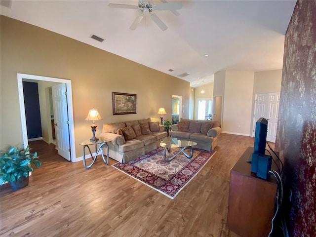 living room featuring ceiling fan, vaulted ceiling, and hardwood / wood-style floors