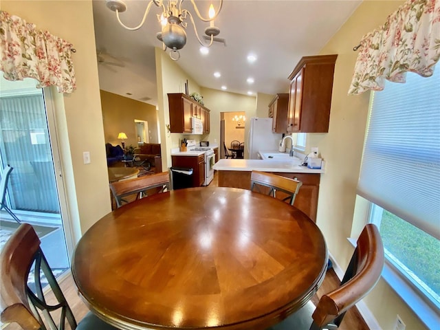 dining area featuring a healthy amount of sunlight, sink, and a chandelier