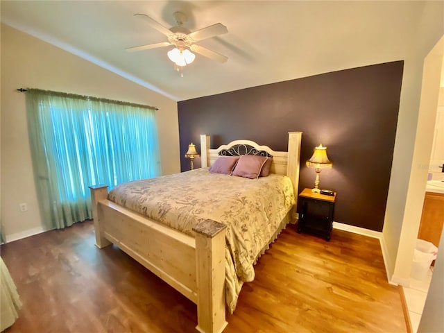 bedroom with ceiling fan, lofted ceiling, and wood-type flooring