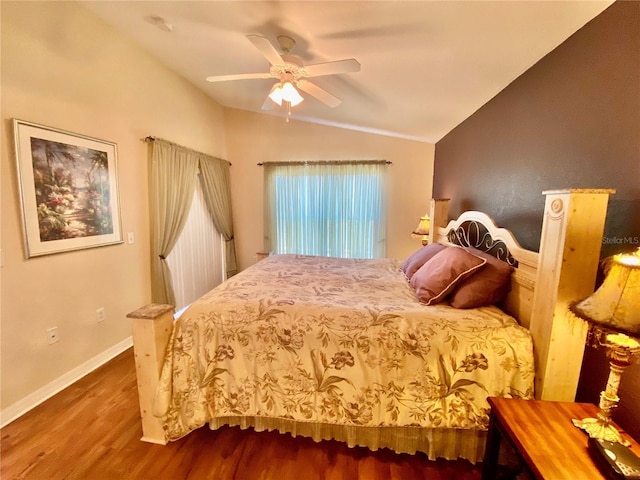 bedroom featuring ceiling fan, wood-type flooring, and vaulted ceiling