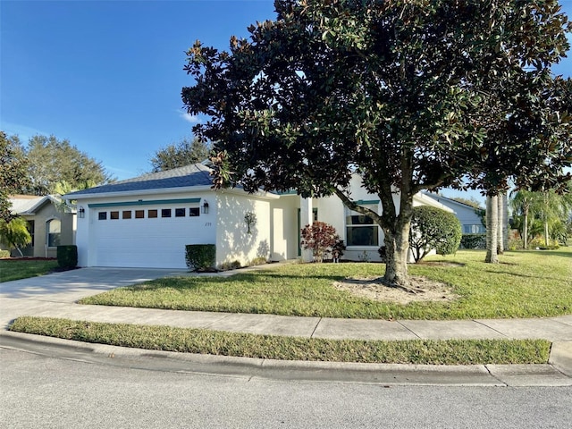 ranch-style home with a garage and a front lawn