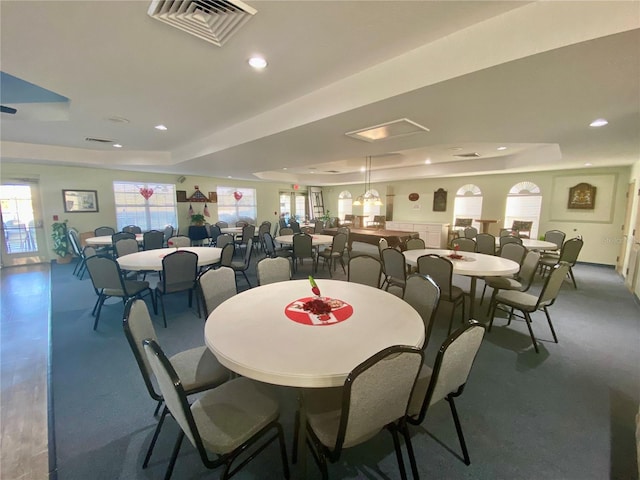 dining space featuring a tray ceiling