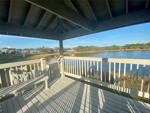 wooden terrace with a gazebo and a water view