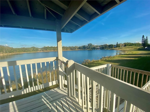 wooden terrace featuring a water view