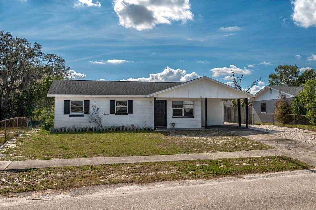 single story home with a carport and a front yard