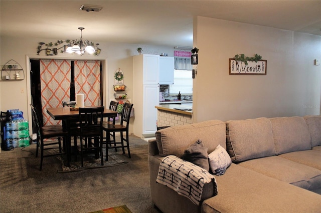 carpeted dining room with a chandelier