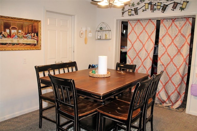 dining space with a chandelier and carpet