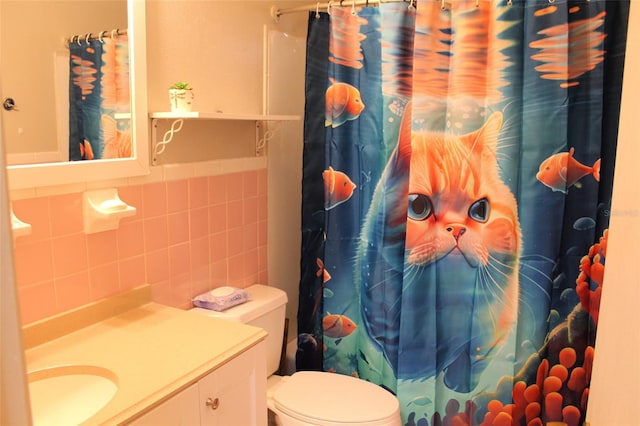 bathroom with vanity, a shower with shower curtain, tile walls, and toilet