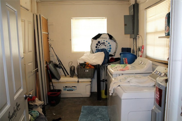 clothes washing area featuring electric panel and independent washer and dryer