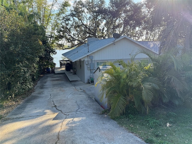 view of property exterior with a water view and a carport