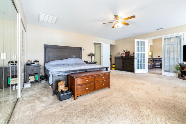 carpeted bedroom featuring a closet, french doors, and ceiling fan