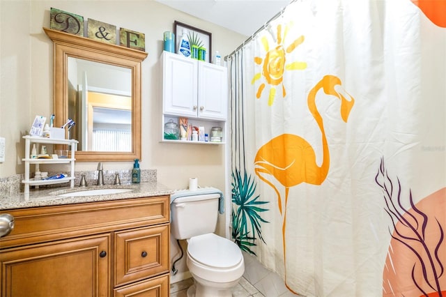 bathroom with vanity, curtained shower, tile patterned floors, and toilet