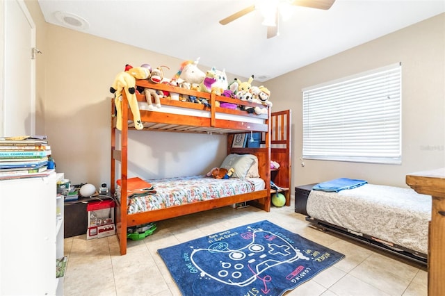 tiled bedroom featuring ceiling fan