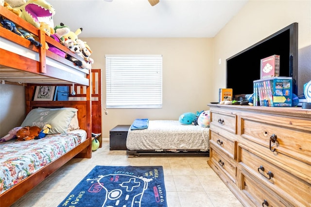 tiled bedroom featuring ceiling fan