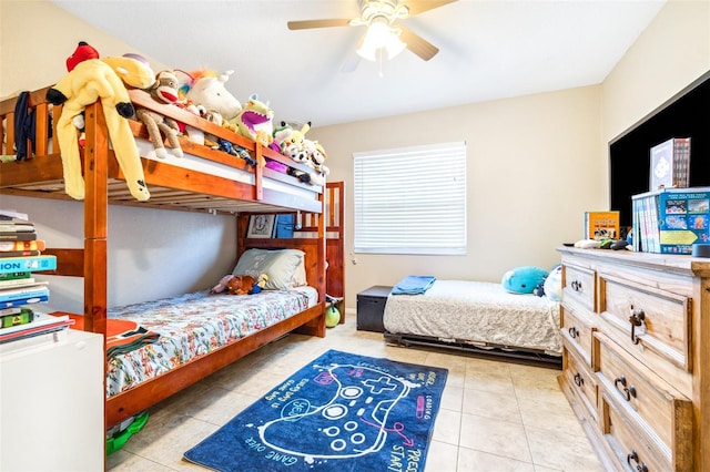 tiled bedroom featuring ceiling fan