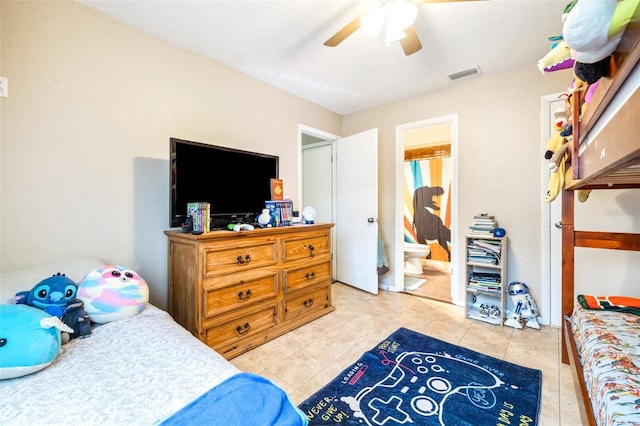 tiled bedroom with connected bathroom and ceiling fan