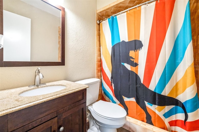 bathroom featuring vanity, a shower with shower curtain, and toilet