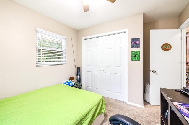 carpeted bedroom featuring a closet and ceiling fan