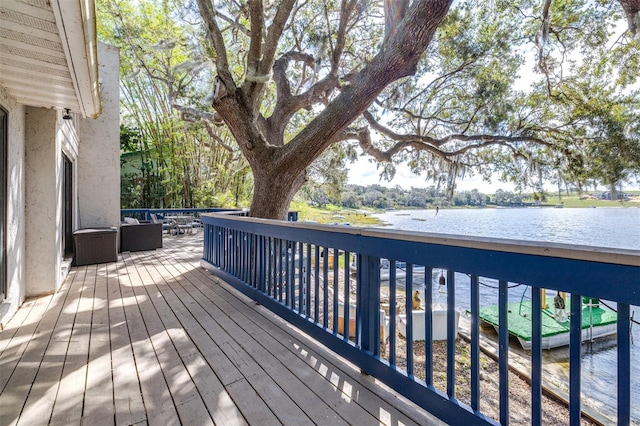 wooden deck featuring a water view