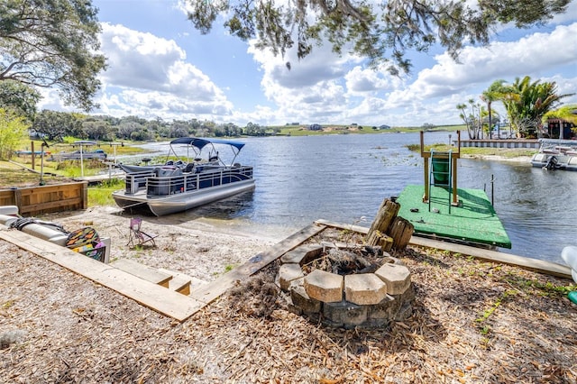 view of dock featuring a water view and a fire pit