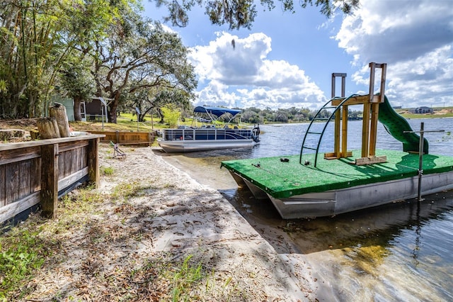 exterior space with a playground and a water view