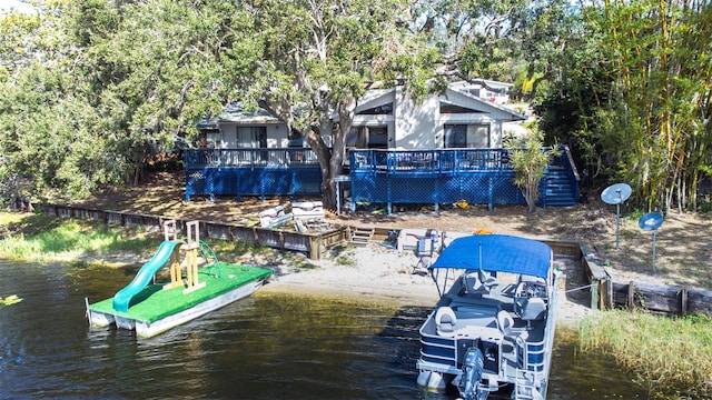 view of dock featuring a water view and a playground