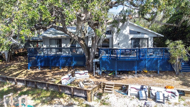 back of house with a wooden deck