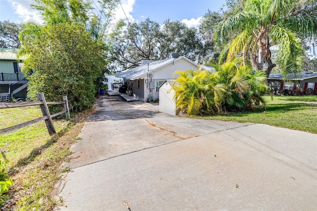 view of property exterior with a lawn