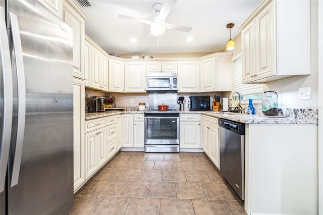 kitchen featuring sink, appliances with stainless steel finishes, pendant lighting, ceiling fan, and light stone countertops