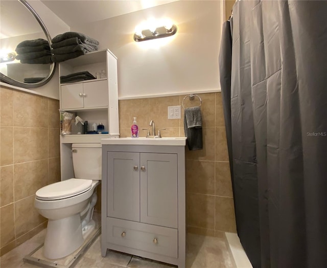 bathroom featuring tile walls, vanity, toilet, tile patterned floors, and a shower with curtain