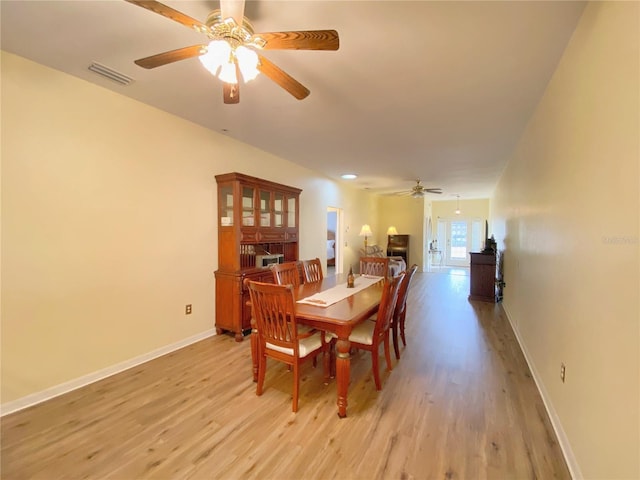 dining area with ceiling fan and light hardwood / wood-style floors