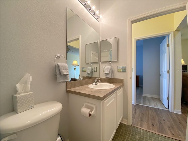 bathroom featuring vanity, hardwood / wood-style floors, and toilet