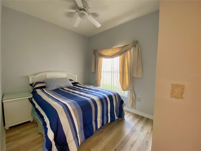 bedroom with ceiling fan and light wood-type flooring