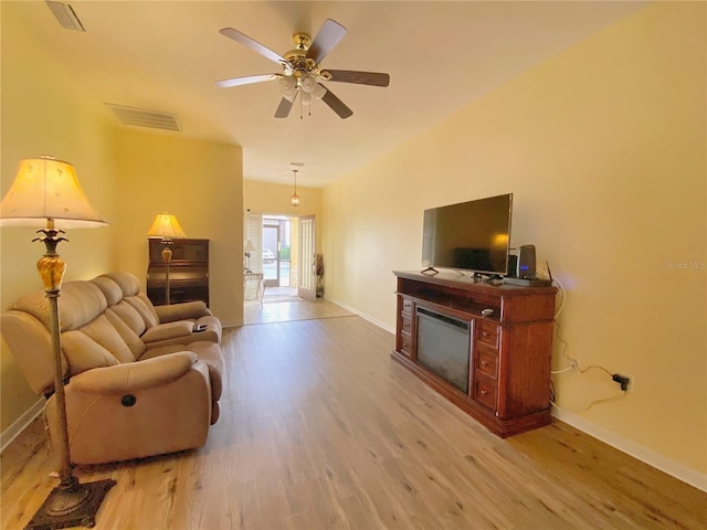 living room with ceiling fan and light hardwood / wood-style floors