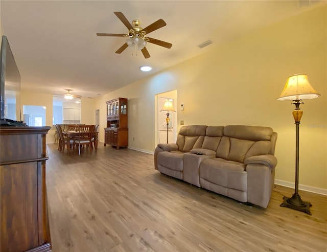 living room featuring ceiling fan and wood-type flooring