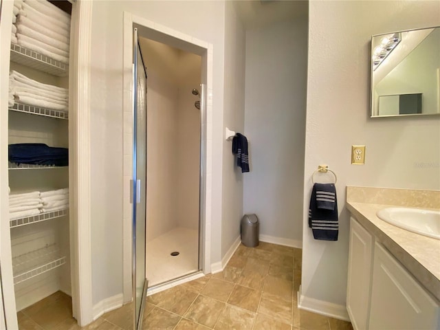 bathroom with vanity and a shower with door