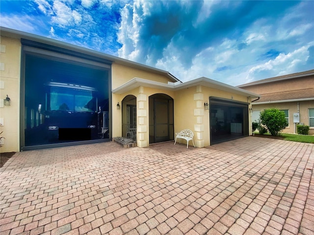 doorway to property with a garage