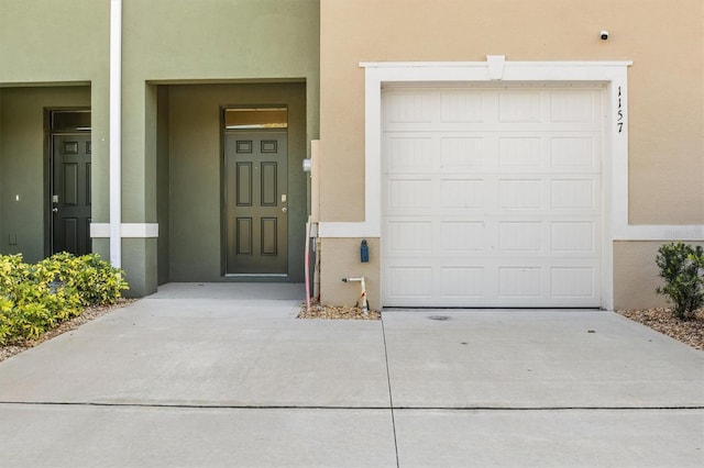 view of exterior entry with a garage