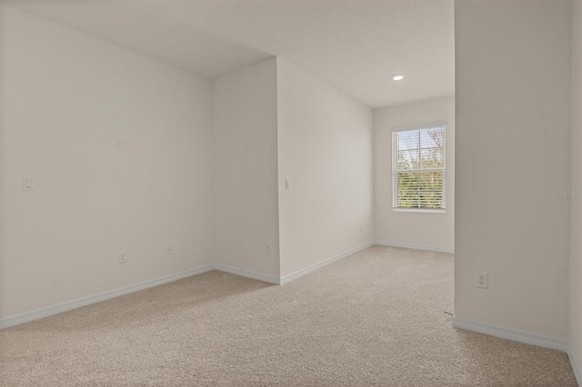 unfurnished room with light colored carpet