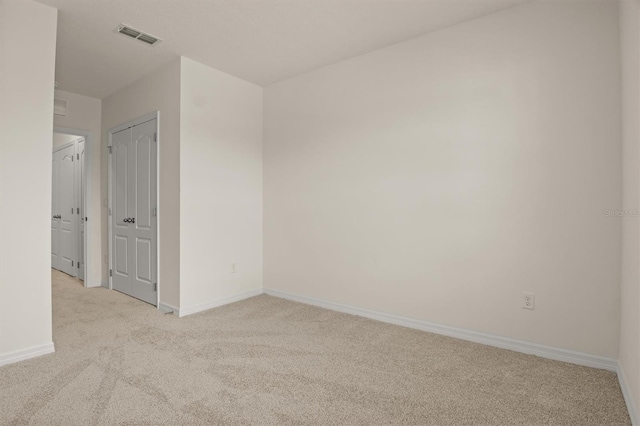 empty room featuring light colored carpet