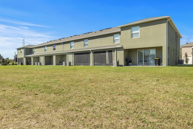 back of property with a yard and cooling unit