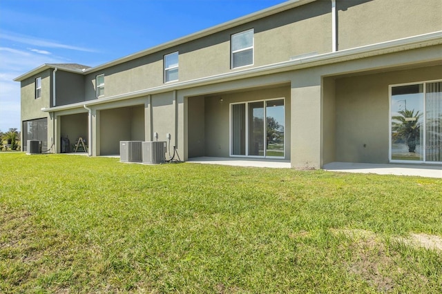 back of property featuring a lawn, central AC unit, and a patio area