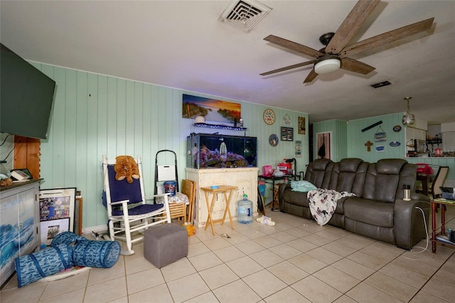 tiled living room with ceiling fan