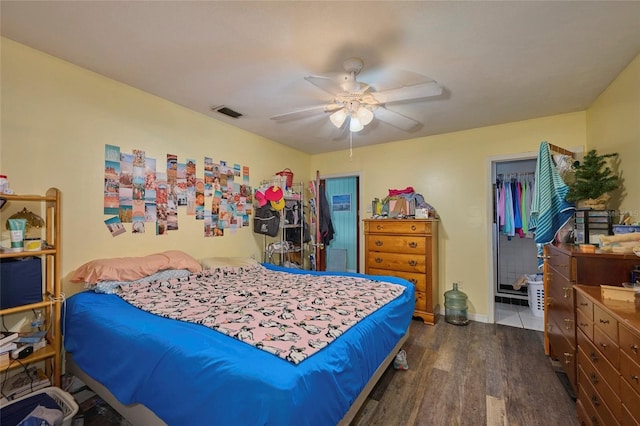 bedroom featuring ceiling fan, dark hardwood / wood-style flooring, a closet, and a spacious closet