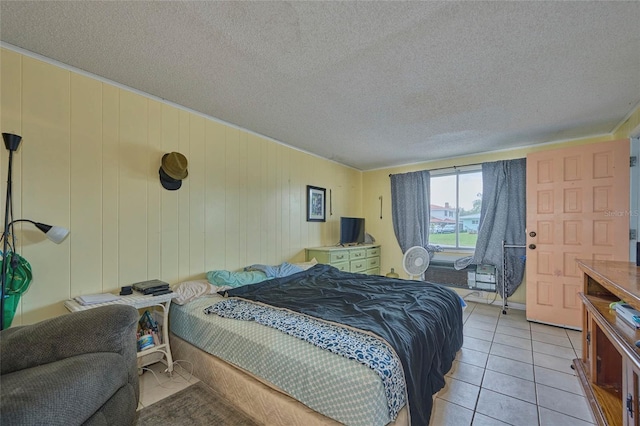 tiled bedroom featuring a textured ceiling