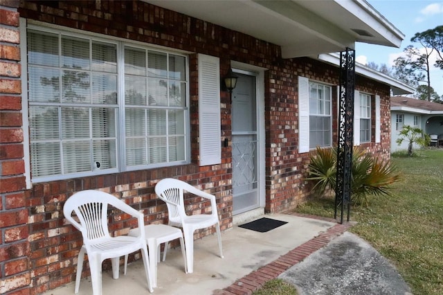 property entrance featuring a yard and a patio area