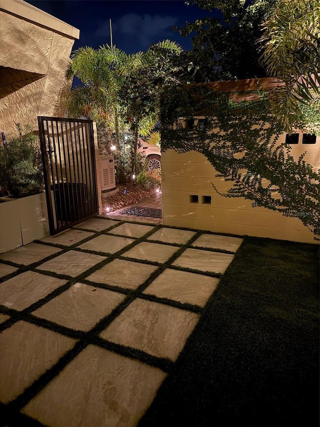 1 Casarena Ct, Winter Haven, FL 33881 - patio at night featuring a gate