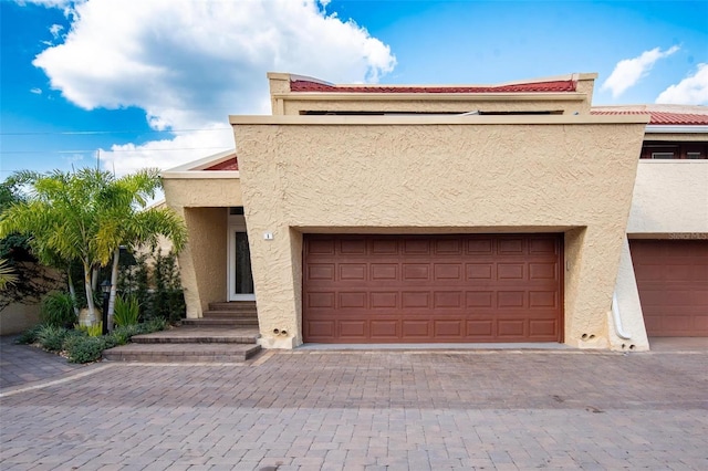 1 Casarena Ct, Winter Haven, FL 33881 - view of front of property featuring a garage, entry steps, and stucco siding