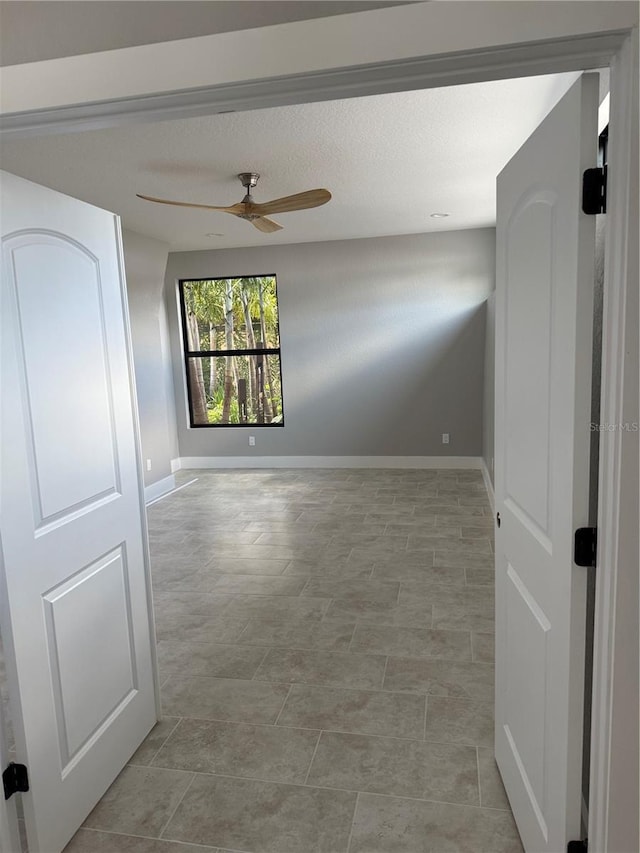 1 Casarena Ct, Winter Haven, FL 33881 - spare room featuring a textured ceiling, ceiling fan, and baseboards
